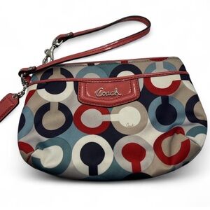 Coach wristlet featuring the Op Art signature pattern